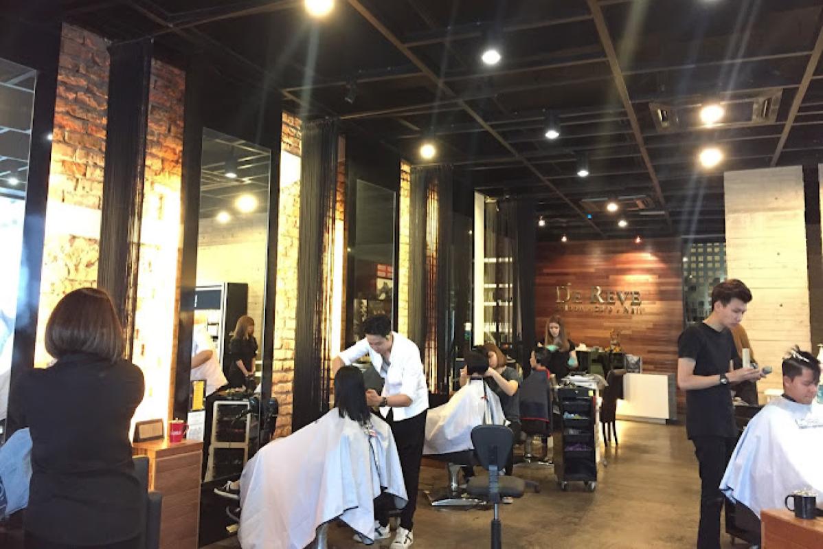 Stylists caring for clients inside DeReve Saloon